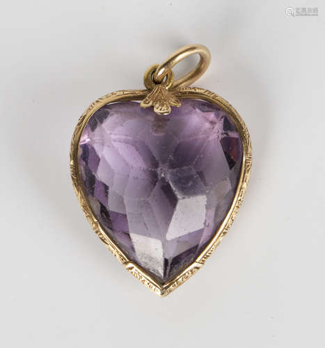 A Victorian gold and amethyst heart shaped pendant, the mount with engraved decoration, length 3.