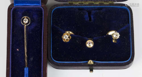 An 18ct gold and circular cut diamond single stone dress stud, detailed '18ct', two other gold and