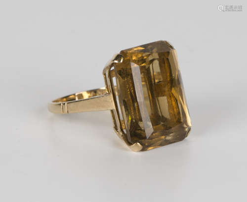 A 9ct gold ring, claw set with a cut cornered rectangular smoky quartz, London 1961, ring size