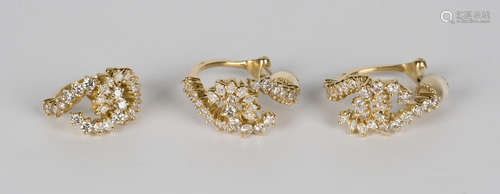 A pair of 18ct gold and diamond Chanel style earclips and a matching ring, each in a scrolling