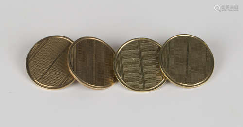 A pair of 9ct gold circular cufflinks with engine turned decoration, London 1938.Buyer’s Premium