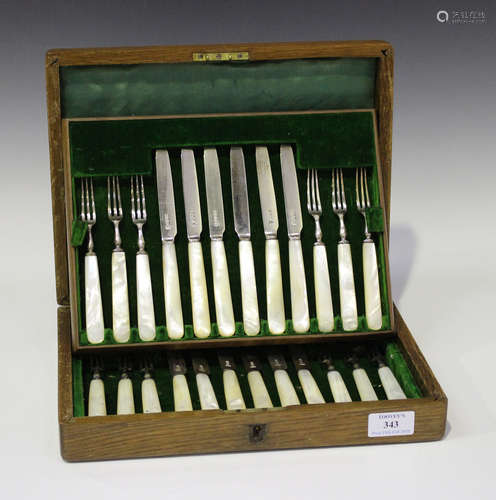 A set of twelve George V silver and mother-of-pearl handled fruit knives and forks, Sheffield 1911