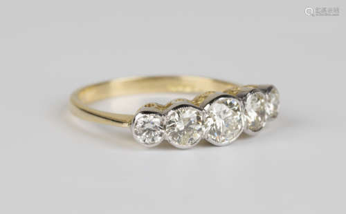 A gold and diamond five stone ring, collet set with circular cut diamonds graduating in size to