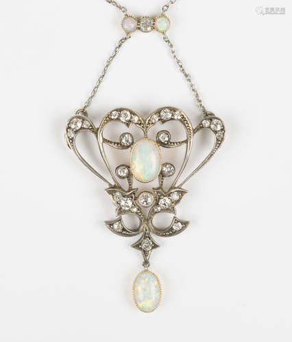 An Art Nouveau gold, opal and diamond pendant necklace in a scrolling design, collet set with a