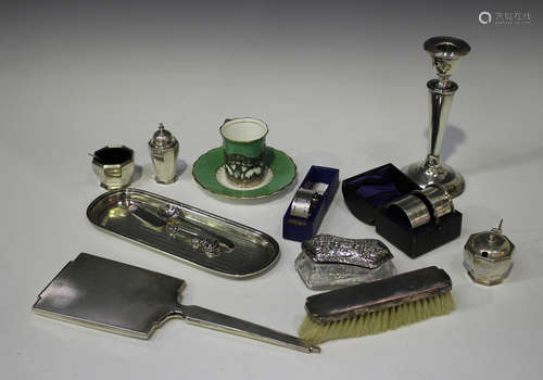 A group of silver items, including a candlestick, London 1919, height 17.7cm, a pin tray with engine