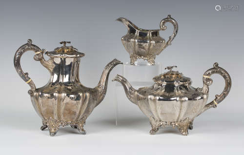 An early Victorian silver three-piece tea set of lobed form with engraved foliate decoration,