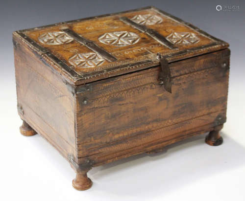 A 19th century Beluchistan carved walnut and metal bound box, the top with hinged compartment,