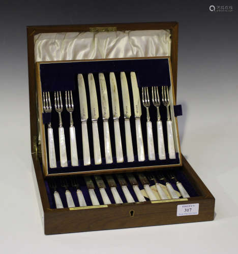 A set of twelve George VI silver and mother-of-pearl handled fruit knives and forks, London 1938 and
