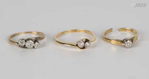 A gold and diamond two stone ring, mounted with cushion cut diamonds in a crossover design, detailed