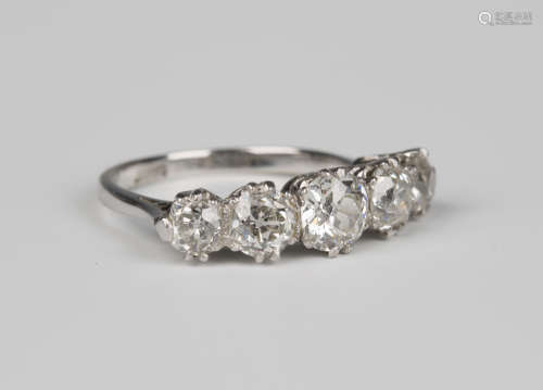 A white gold, platinum and diamond five stone ring, claw set with a row of graduated cushion cut