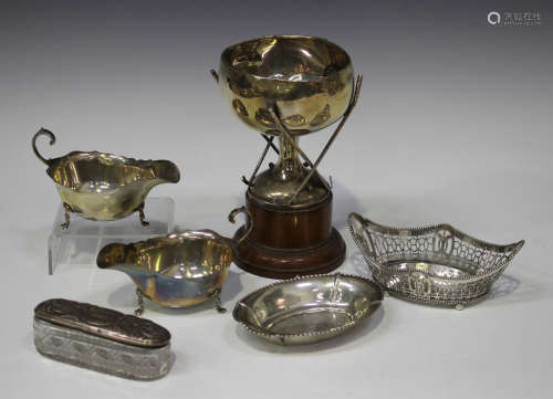 A pair of George V silver sauce boats with shaped rims and scroll handles, Birmingham 1913 by Adie