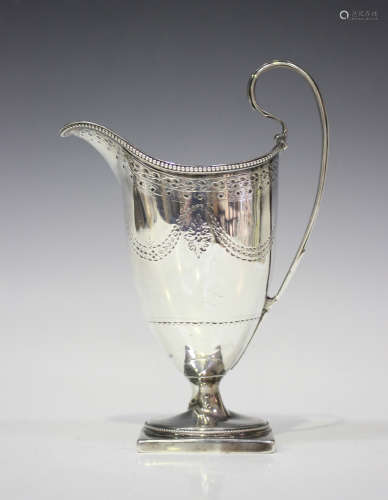 A George III silver helmet cream jug with beaded rim, engraved with foliate swags, on a square base,