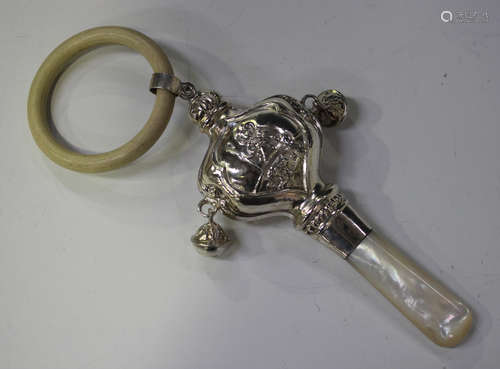 An Edwardian silver baby's rattle, the body embossed with opposing panels of Bo Peep flanked by