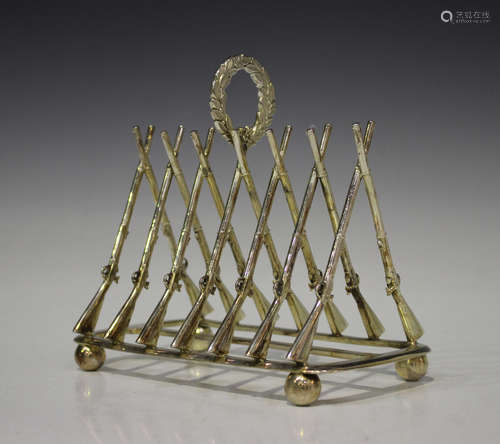 A Victorian plated six-division toast rack, circa 1871, each division modelled as a pair of