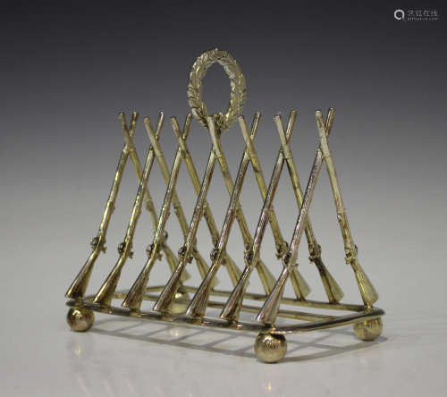 A Victorian plated six-division toast rack, circa 1871, each division modelled as a pair of