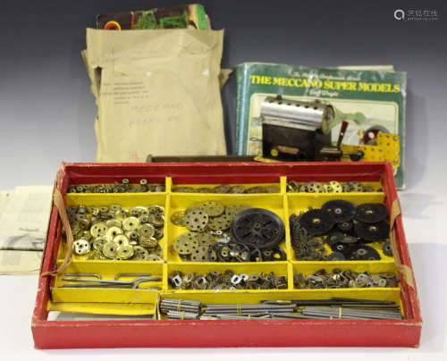 A collection of Meccano red and green parts, a clockwork motor, instructions etc (playwear and