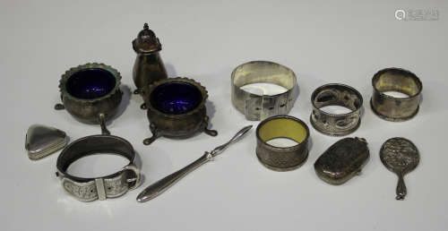 A small group of silver and plated items, including a George V sovereign and half-sovereign case