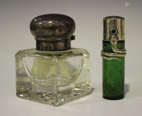 A late Victorian silver mounted green glass cylindrical scent bottle, the hinged lid set with a