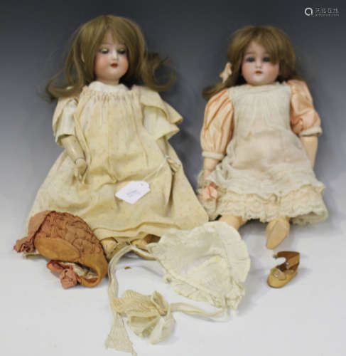A Schoenau & Hoffmeister bisque head doll, impressed '1909 2/0', with brown wig, sleeping blue eyes,