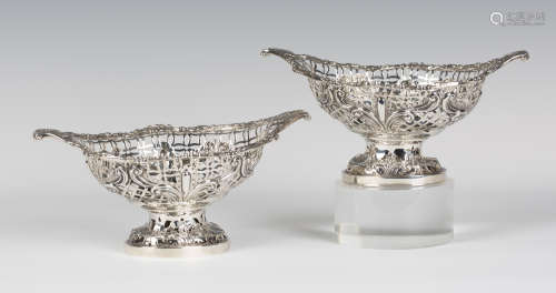 A pair of George V silver oval sweetmeat baskets, each cast and pierced with foliate scrolling