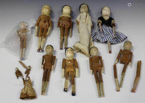 A 20th century Victorian style wooden peg doll with painted features and jointed body, height