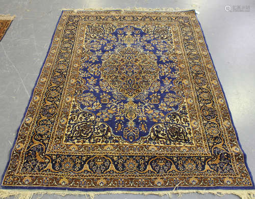 A Kerman rug, Central Persia, early/mid-20th century, the blue field with a shaped medallion