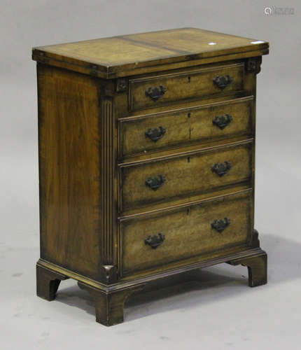 A 20th century George III style walnut bachelor's chest, the hinged top above four long drawers,