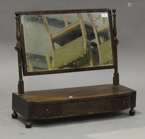 A George III mahogany swing frame toilet mirror, the base fitted with three drawers, on turned feet,