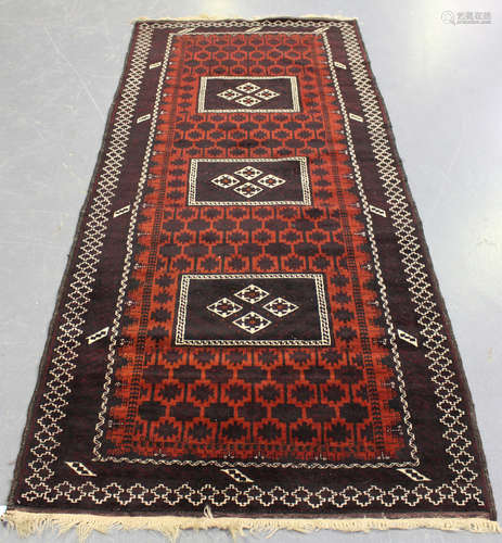 A Beluche runner, Afghan/Persian borders, late 20th century, the deep claret field with three