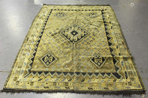 A Shiraz rug, South-west Persia, early/mid-20th century, the faded taupe field with a lozenge