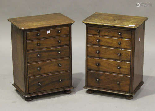 A pair of 19th century mahogany table-top chests of five graduated long drawers, on bun feet, height