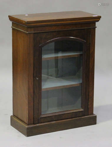 A Victorian mahogany display cabinet, the arch glazed panel door revealing a blue painted