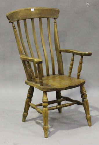 A 20th century beech and elm bar back Windsor armchair, the solid seat raised on turned legs