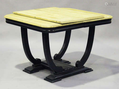 An Art Deco oak and ebonized extending dining table with two extra leaves, the rectangular top