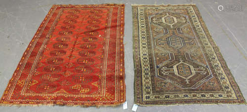 A Turkestan rug, early/mid-20th century, the red field with two columns of guls, within a hooked