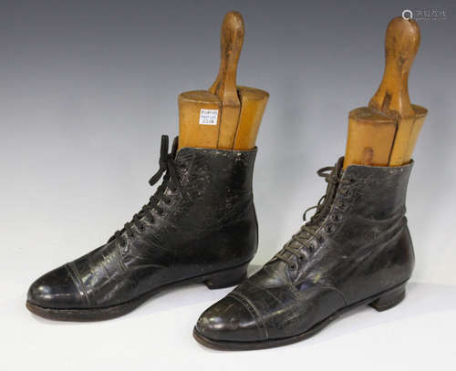 A pair of Victorian black leather lady's boots, both fitted with wooden lasts.Buyer’s Premium 29.