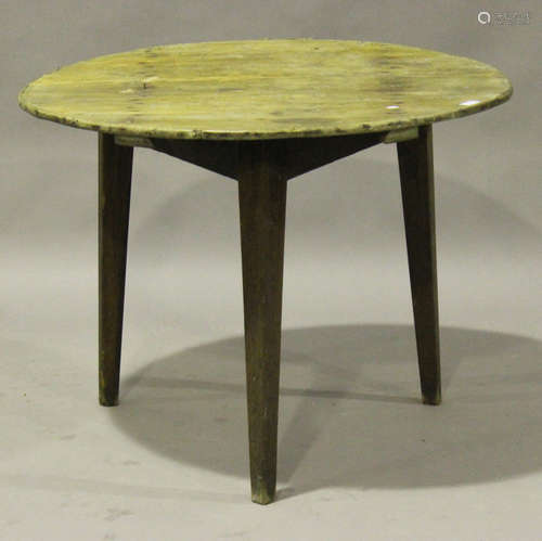 A 19th century provincial pine and ash cricket table, the circular top raised on three square