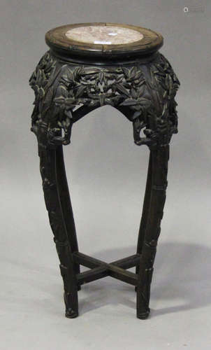 A Chinese hardwood jardinière stand, the top inset with rouge marble above a carved and pierced