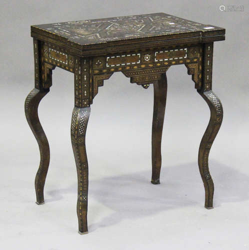 A 19th century Damascus ware fold-over games table with geometric inlaid decoration, raised on