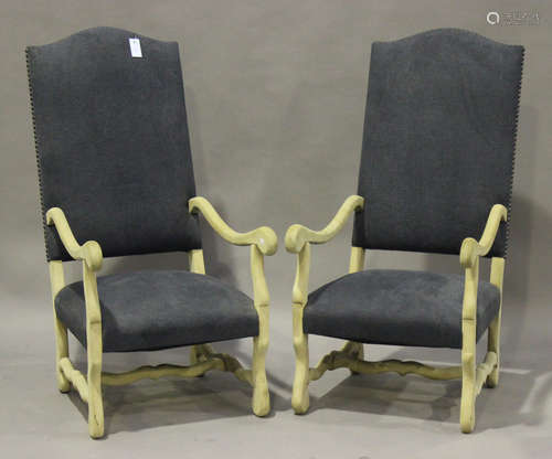 A pair of 20th century French stripped ash open armchairs, upholstered in blue fabric, raised on