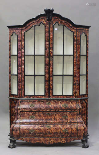 A 20th century Dutch style faux-tortoiseshell veneered vitrine, the arched top fitted with a pair of