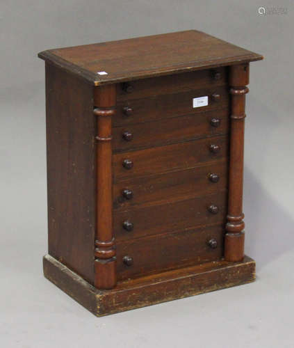 A late Victorian stained pine table-top collector's chest of seven graduated drawers, fitted with