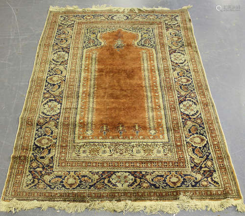 A Kayseri part silk rug, Turkey, 20th century, the apricot mihrab within a palmette and curled