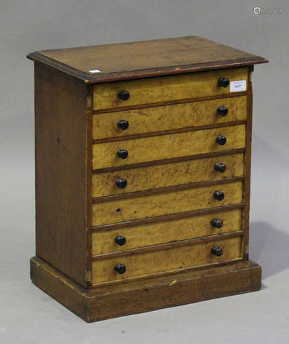 A late Victorian stained pine and bird's eye maple table-top collector's chest of seven drawers,