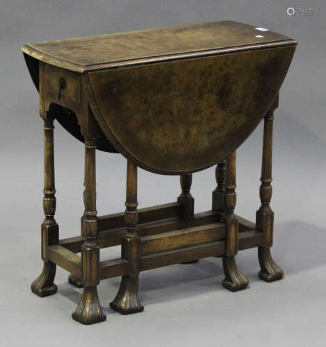 A 20th century Charles I style walnut oval Sutherland table, the crossbanded top raised on turned