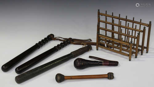 A group of collectors' items, including three turned wooden truncheons, a sailor's cudgel and a