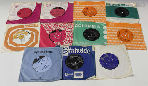 A small collection of single records, including 'I'll Go Crazy' by The Untamed, 'Little Baby' by The