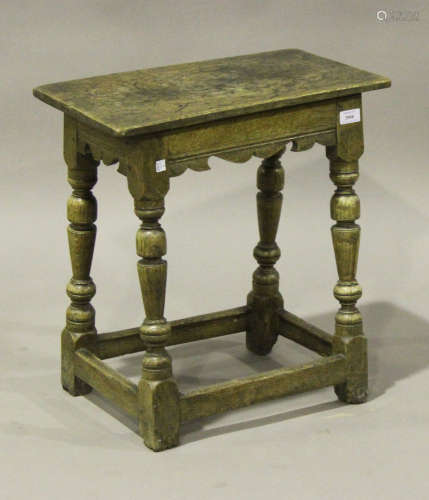 A late 17th century oak joint stool, the rectangular top above a shaped frieze, raised on turned and