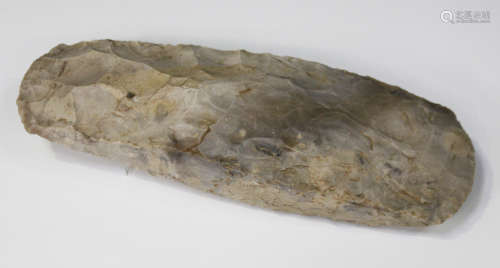 A Danish Neolithic chipped flint axe, indistinctly inscribed 'Denmark', length 25cm.Buyer’s
