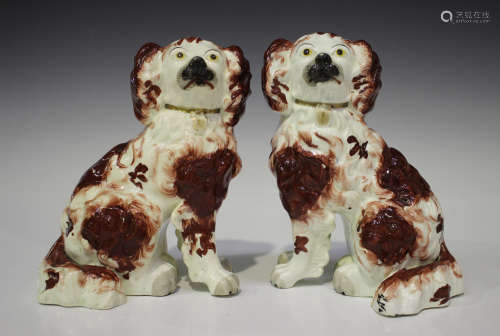 A pair of porcelaneous Staffordshire models of spaniels, early 19th century, with iron red